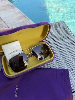 Gucci Men’s GG0529S  Silver Frame Sunglasses with Brown Lenses and Purple Case